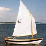 SHELLBACK SKIFF, in water sails up starboard side view