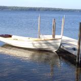 Penobscot 13 wooden sailboat, docked starboard side view
