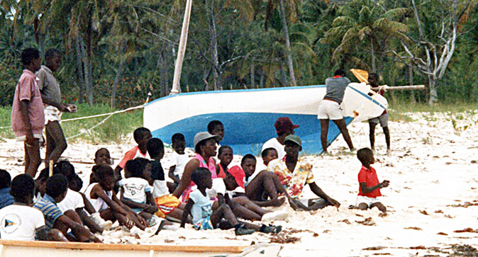 Bahamian fishing sloop beached for painting.