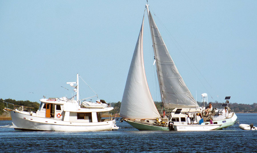 A trawler and motorsailer hard aground.